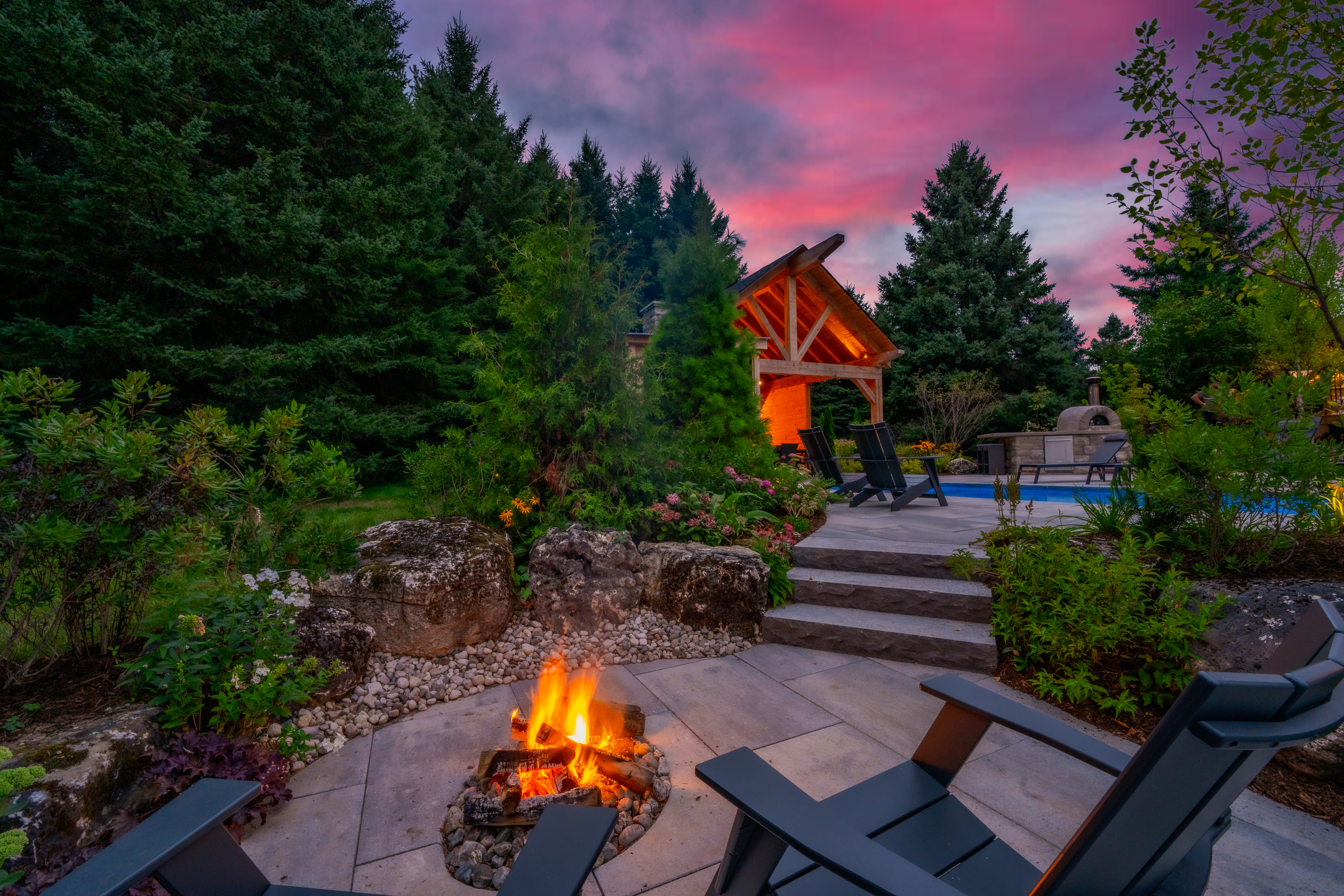 Biase project pool and pavilion at dusk by Headwaters Landscape Design & Construction